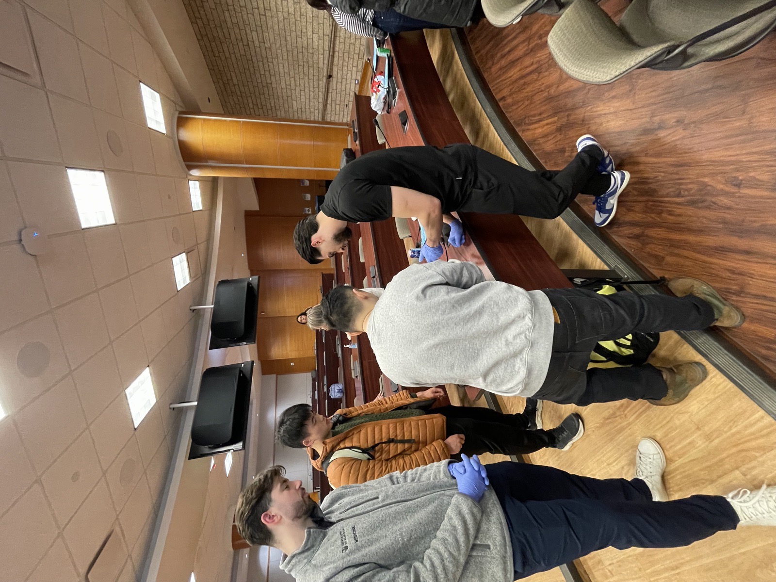 Medical trainees practising biopsy techniques together at a SkinCourses workshop